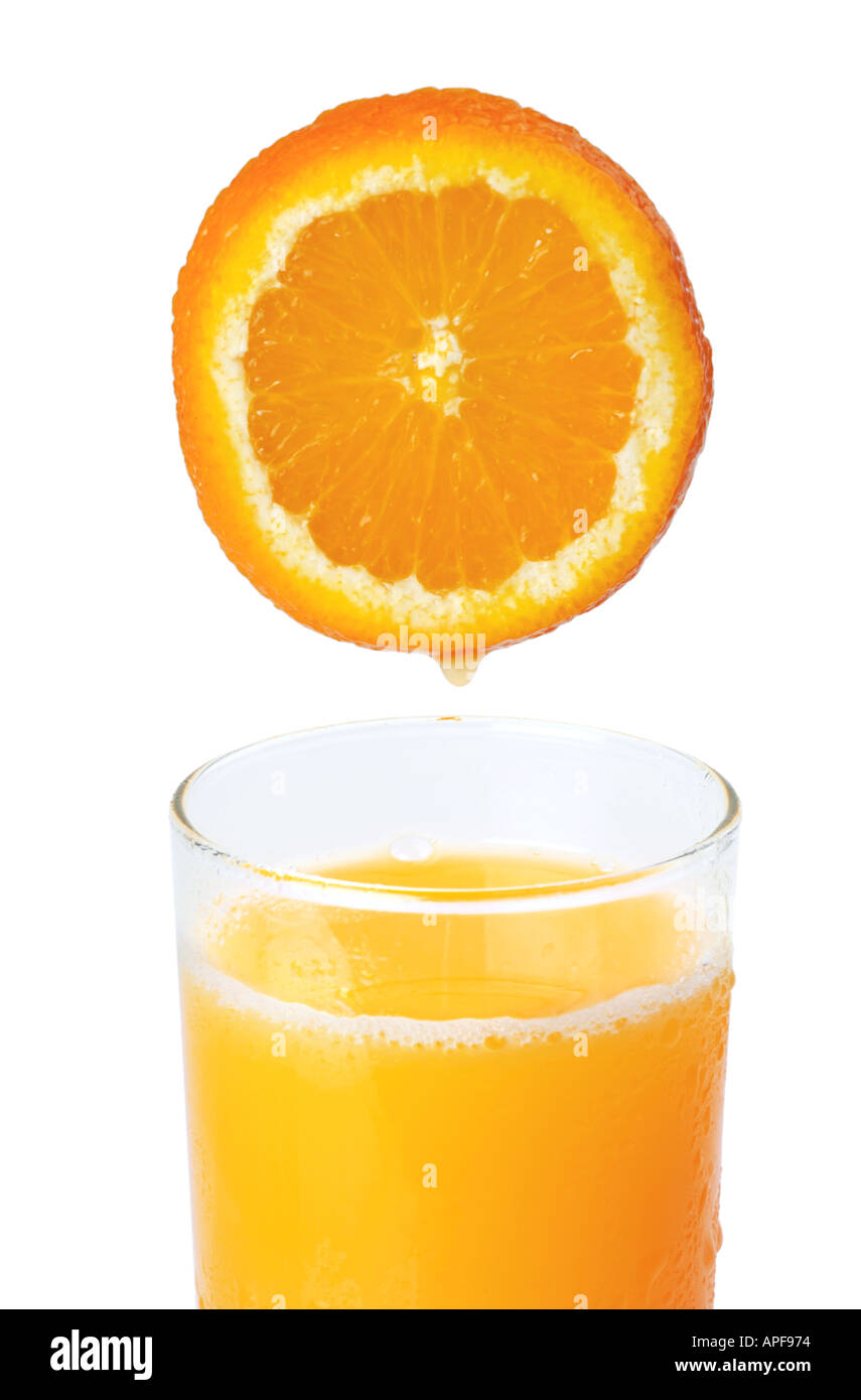 Fresh squeezed orange juice Slice of orange dripping into glass Stock