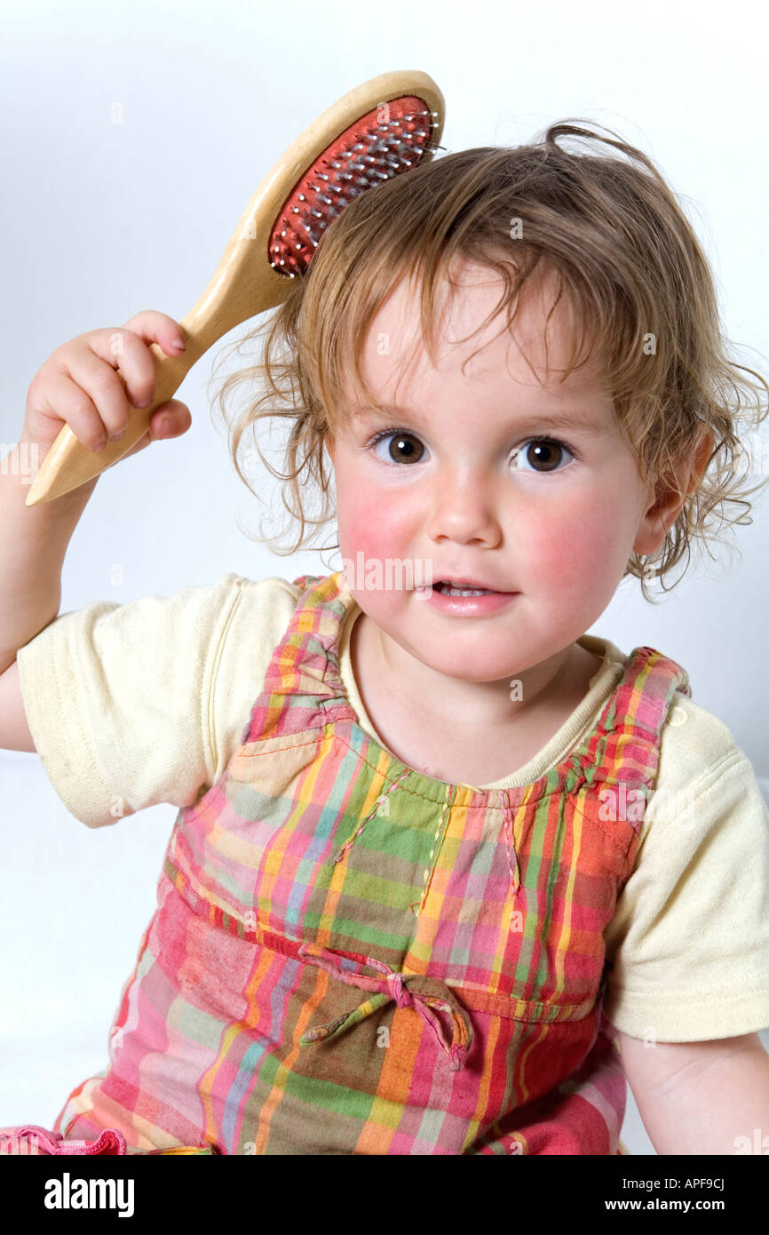 Young child brushing her hair Stock Photo Alamy
