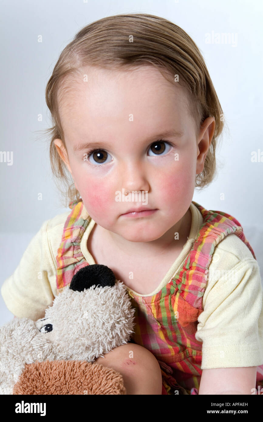 Young child holding a stuffed animal Stock Photo Alamy