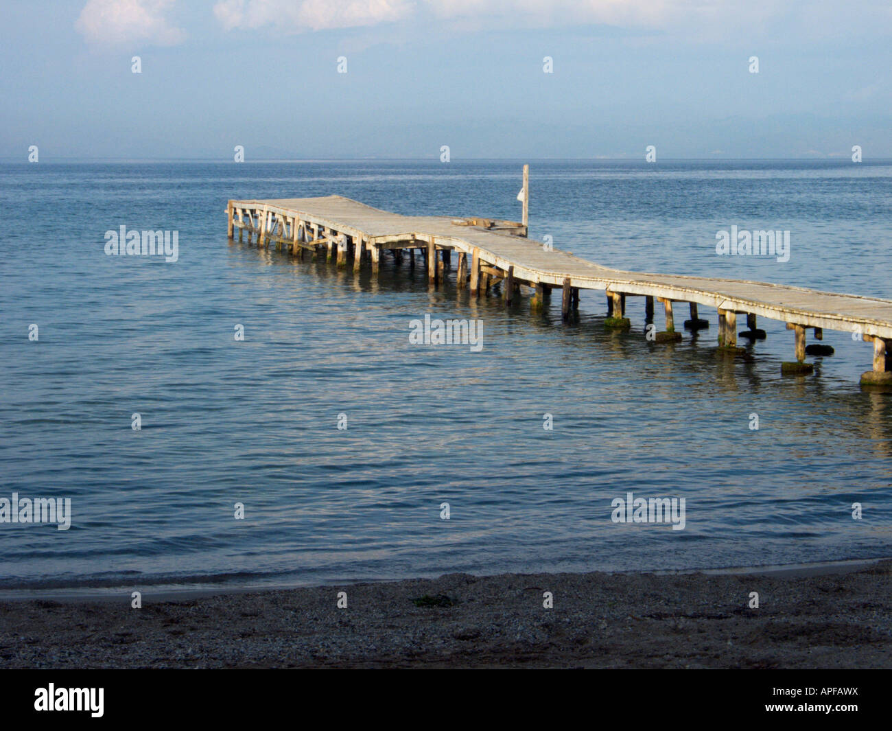 An empty wooden jetty projecting into the Adriatic at Messongi, Corfu on a calm summers day Stock Photo