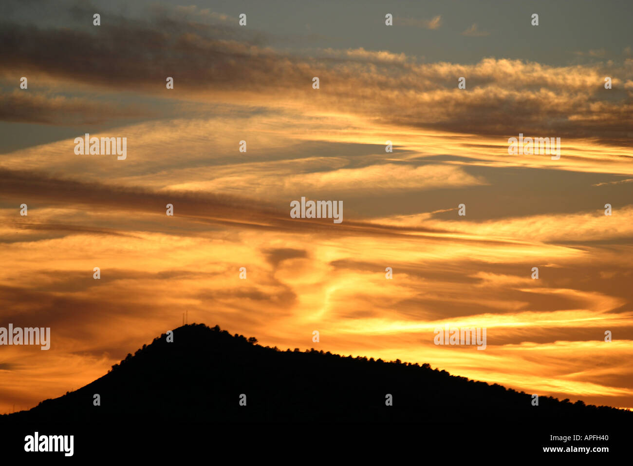 Sunset over mountain Stock Photo - Alamy