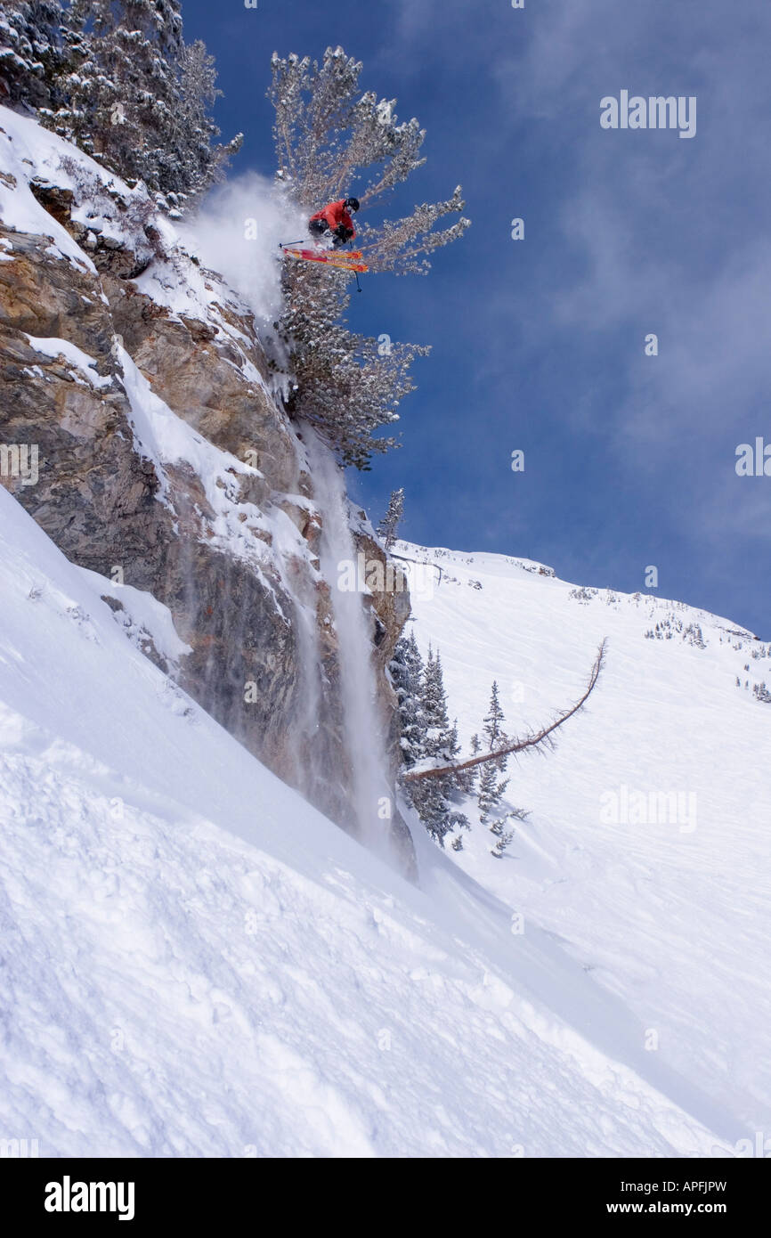Male telemark skier jumping off a cliff at Alta Ski Area in Utah Stock