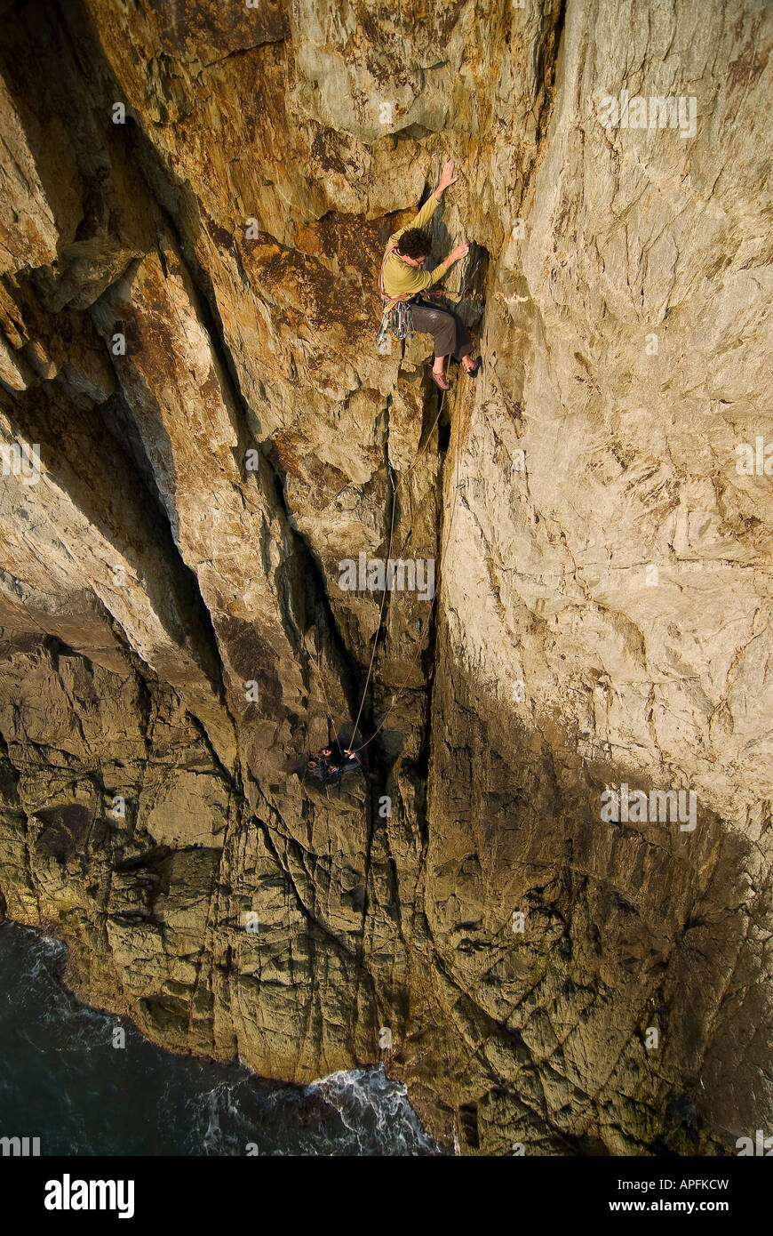 rock Climbing, sea clif, climber in extremis Stock Photo