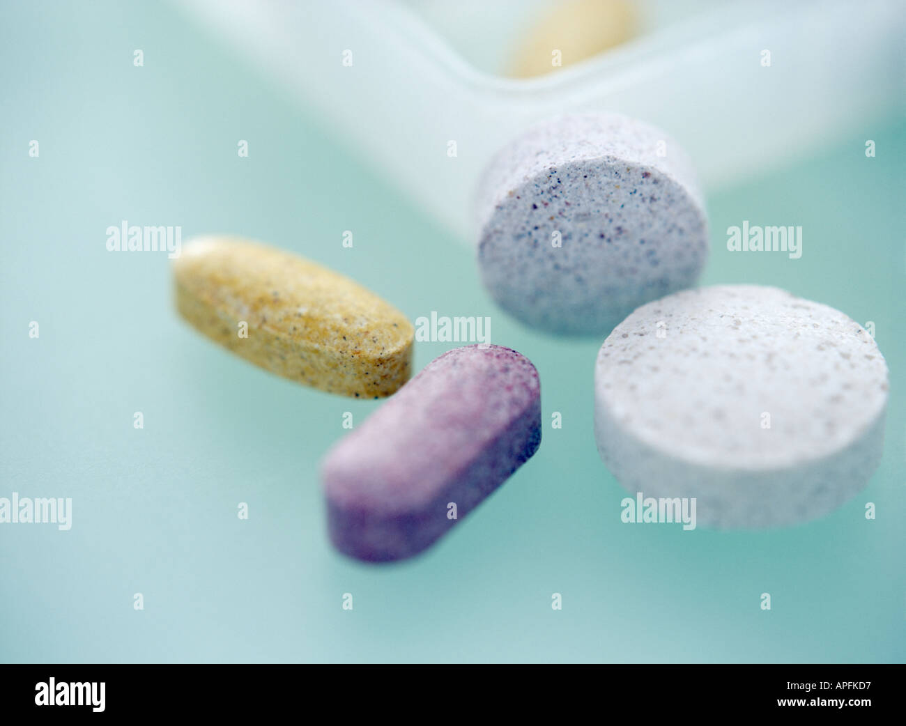Vitamin pills on pale green background Stock Photo
