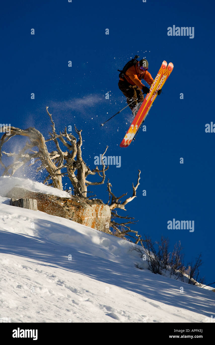 Telemark skier Eben Mond jumping and doing a tip grab on Patsy Marley