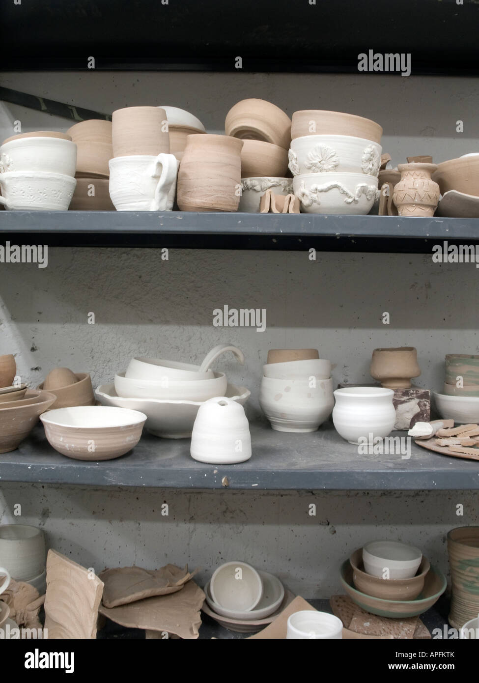 Pottery waiting to be glazed after coming out of the bisque Stock Photo Alamy