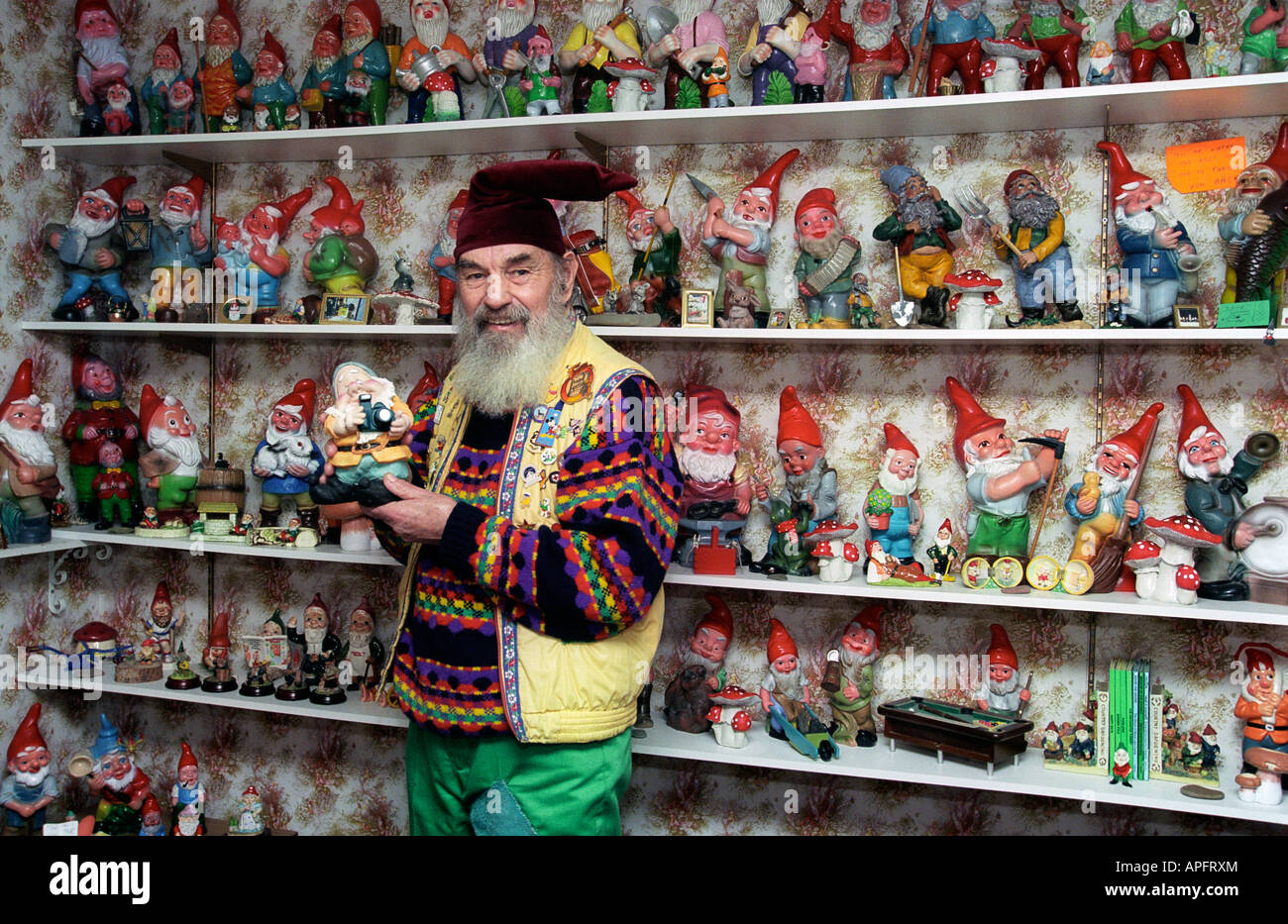 Man posing and showing his collection of garden gnomes Stock Photo