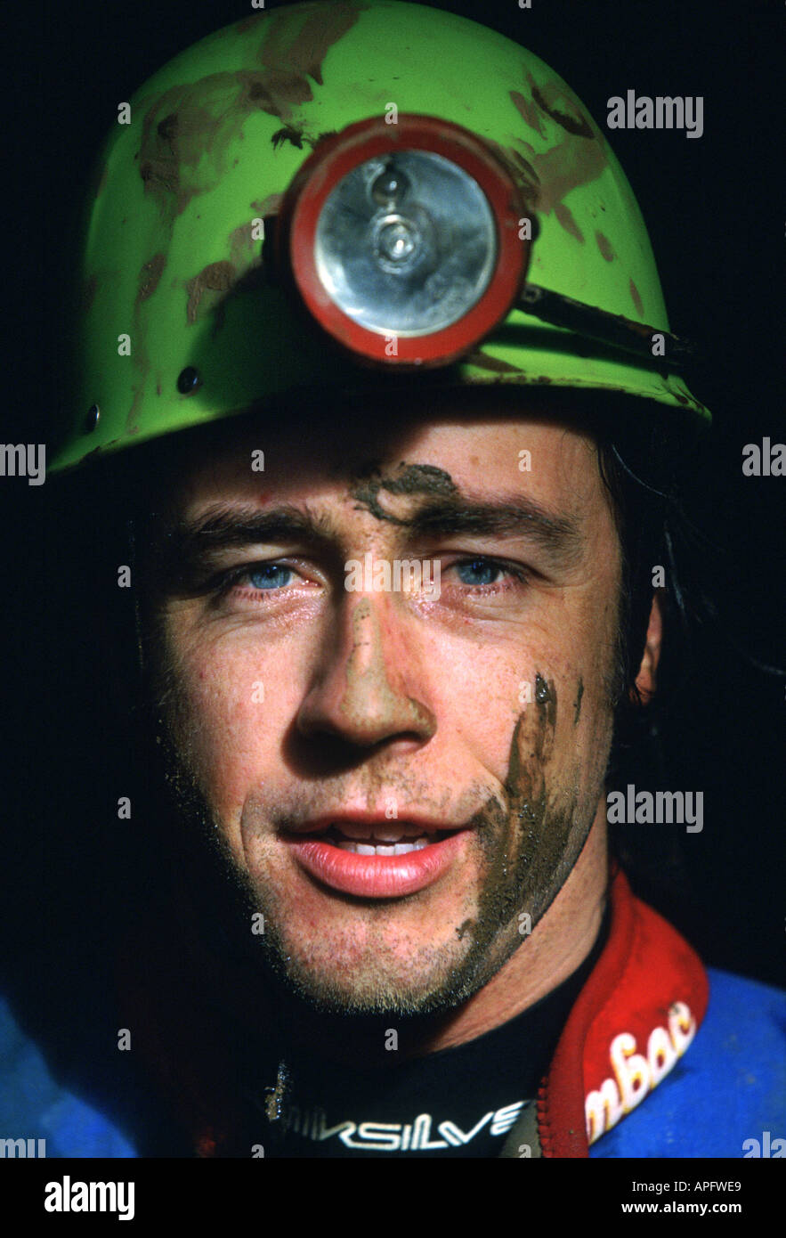 Portrait of pot holer with head torch, Devon, UK Stock Photo