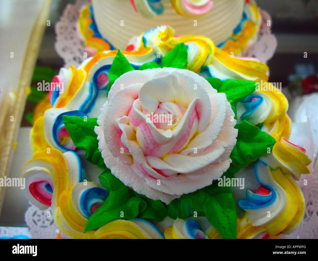 A selection of frosted cakes in a display case in a bakery Stock Photo