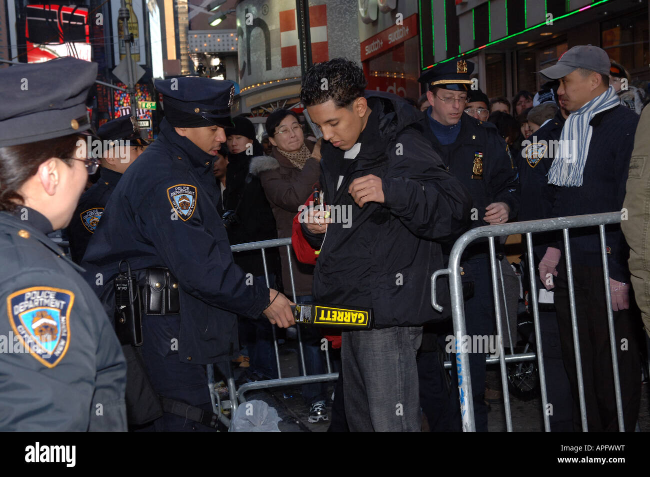 NYPD officers use metal detectors on celebrants entering Times Sqaure on New Year s Eve Stock Photo
