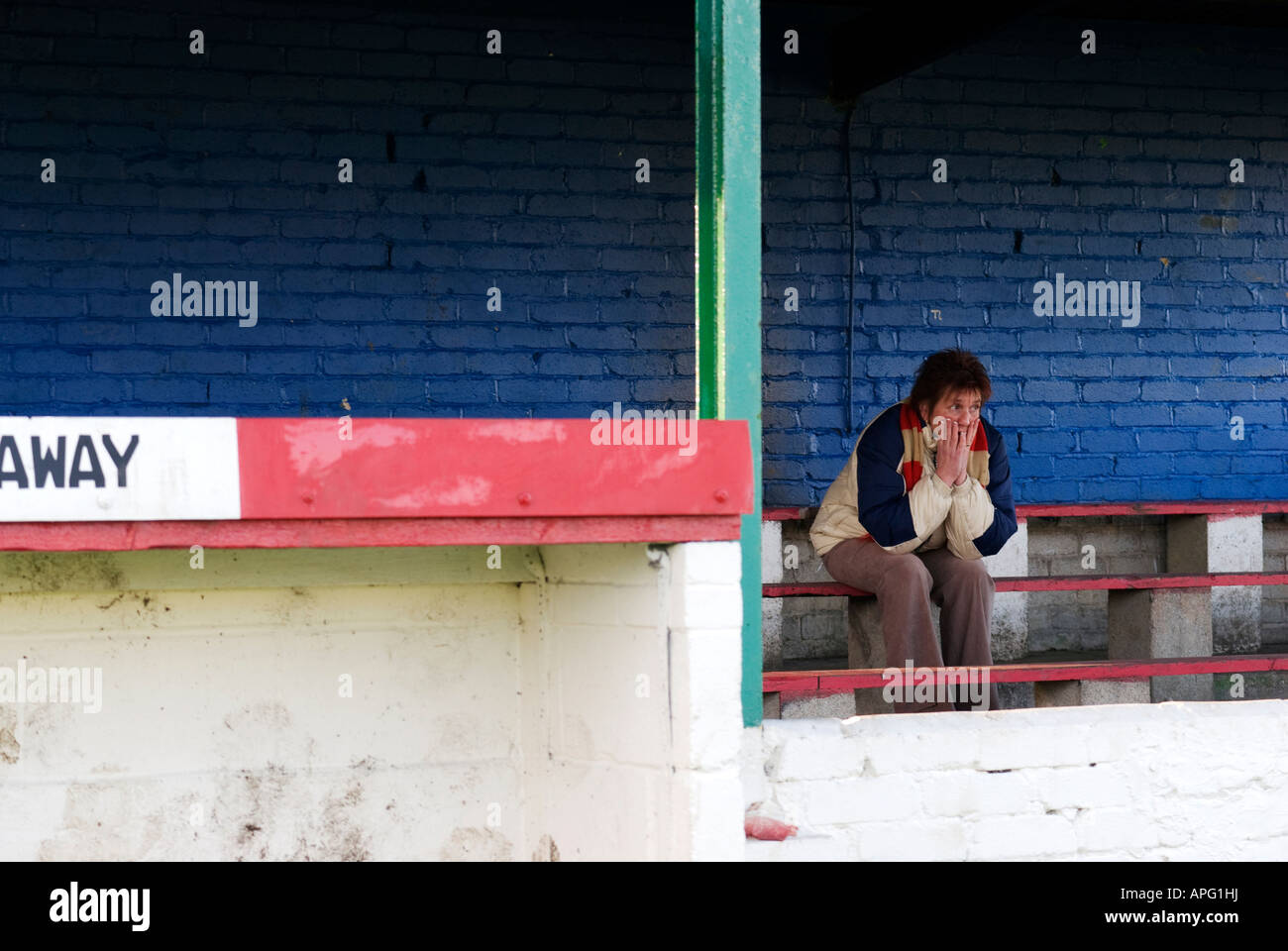 lone football fan on terrace with head in hands Stock Photo