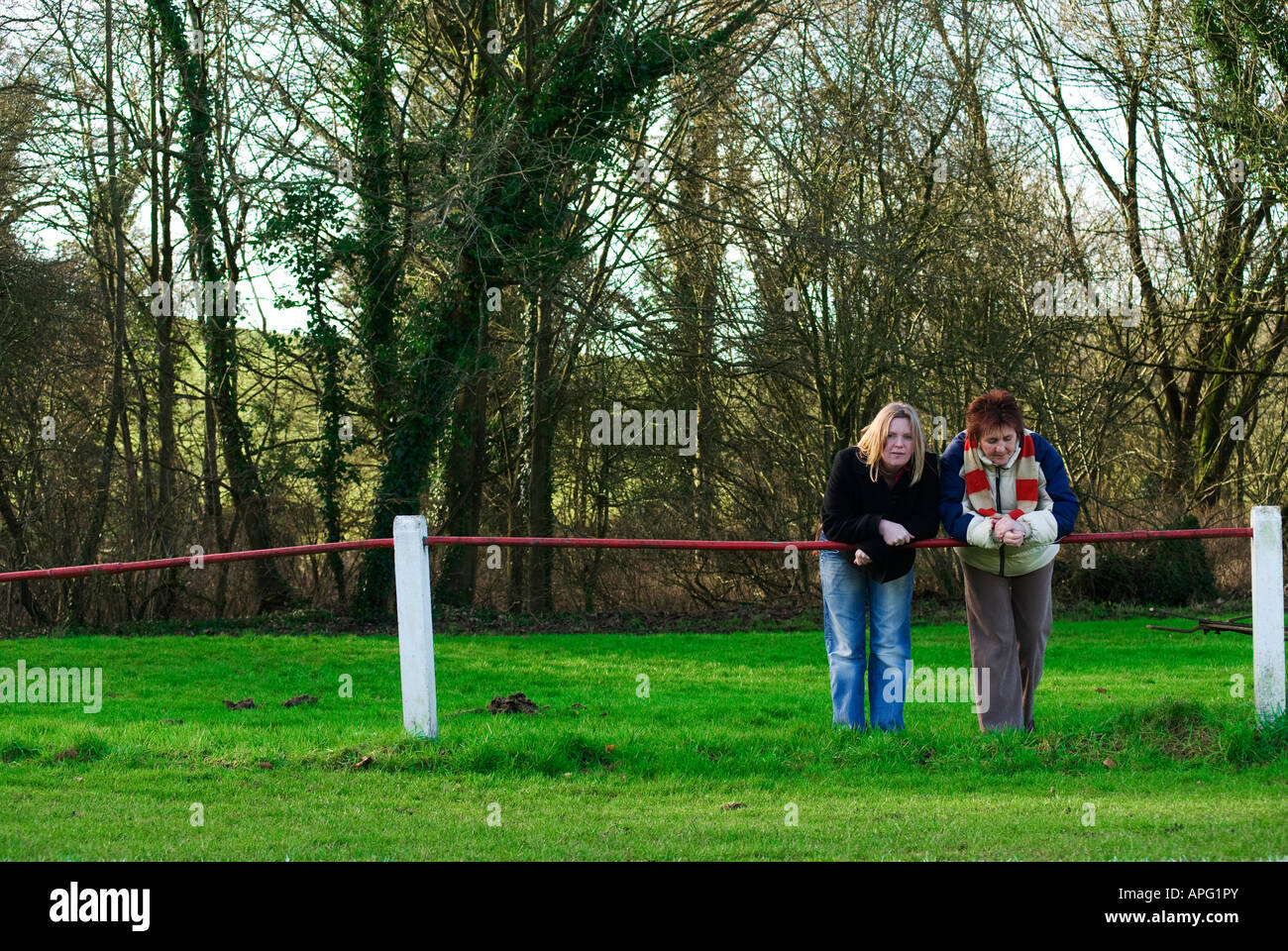female sports fans leaning on metal barrier Stock Photo Alamy
