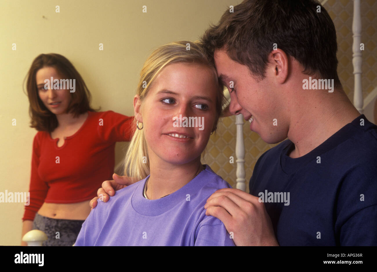 girl looking jealously at another girl with a boy Stock Photo