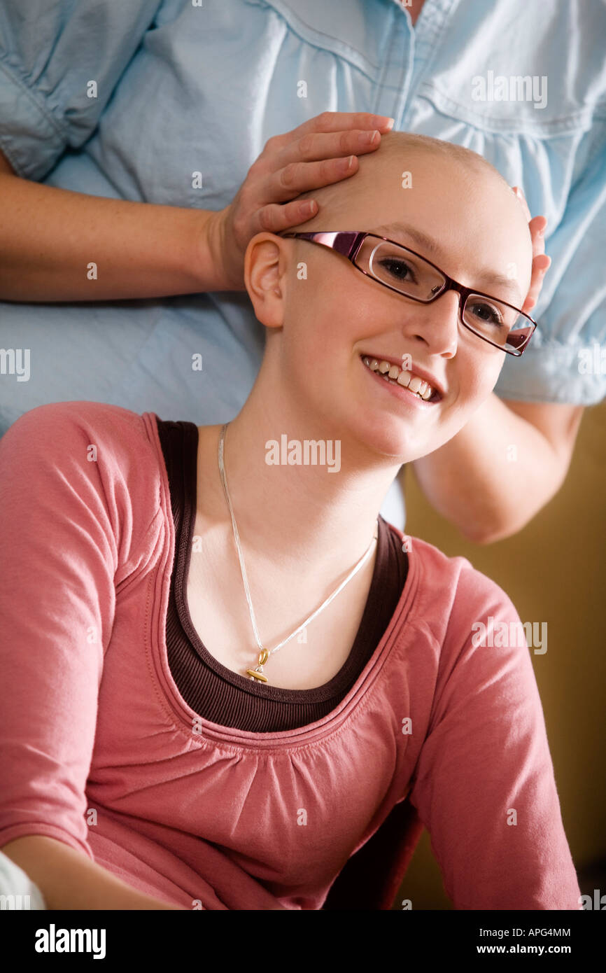 Woman holding girl's bald head Stock Photo - Alamy