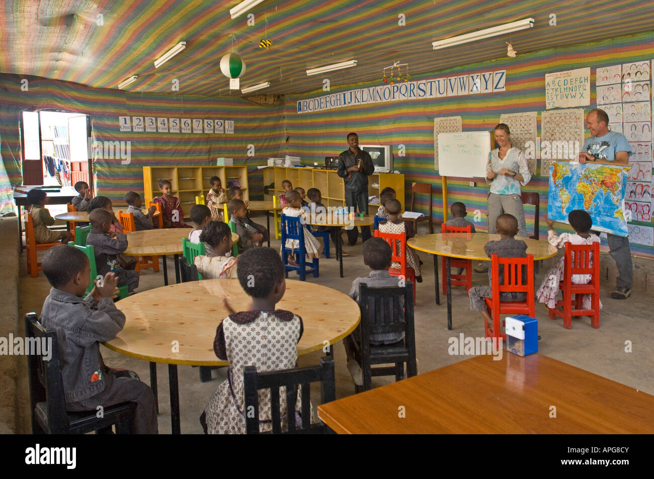 The children pay attention to the teachers in the classroom of a charity run school. Stock Photo