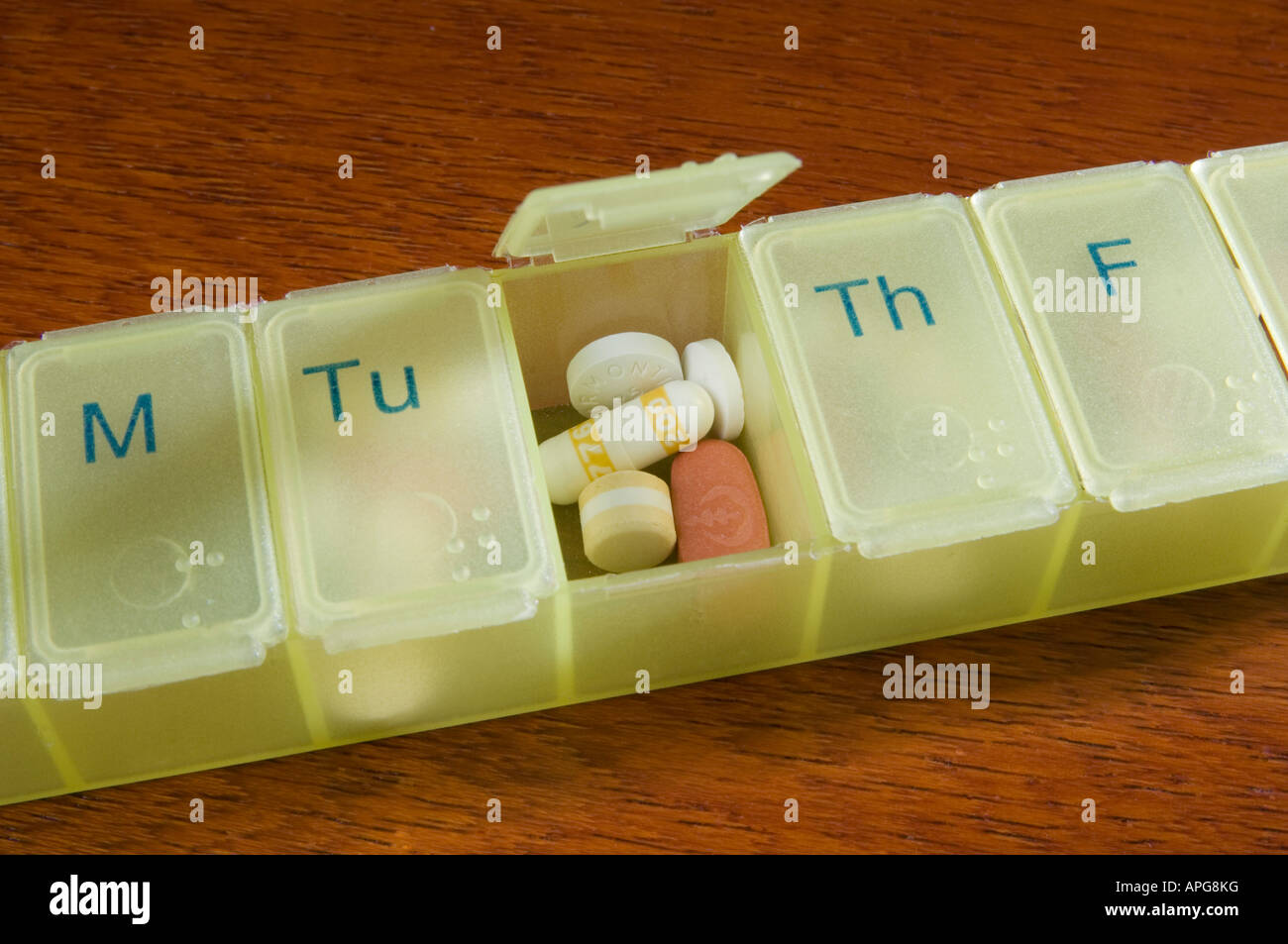 Medications pills tablets and capsules in a daily pill organiser box Stock Photo