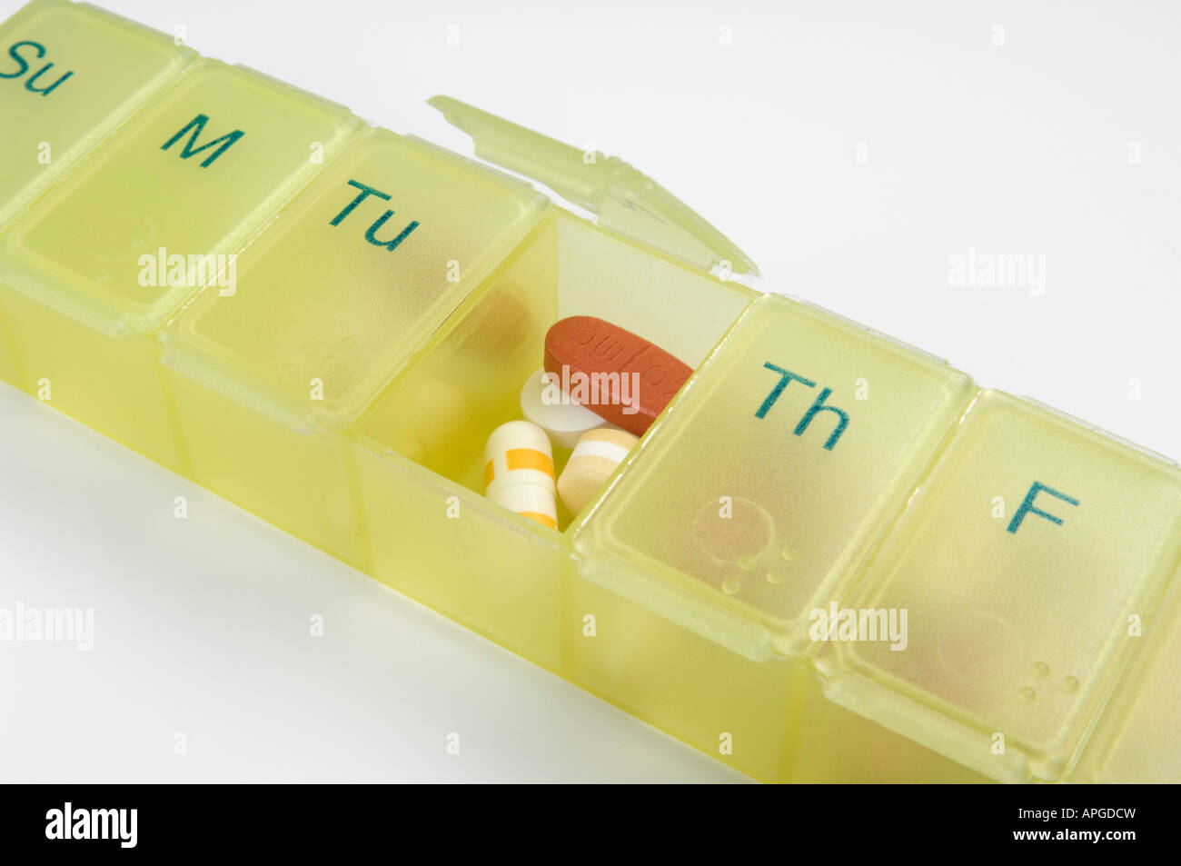 Medications pills tablets and capsules in a daily pill organiser box Stock Photo
