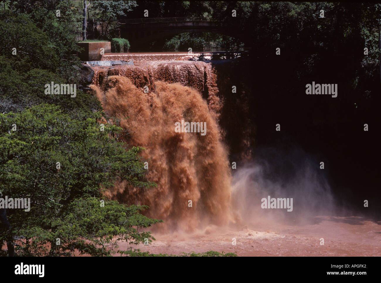 Falls on the Thika River red with mud after heavy rains Kenya East Africa Stock Photo