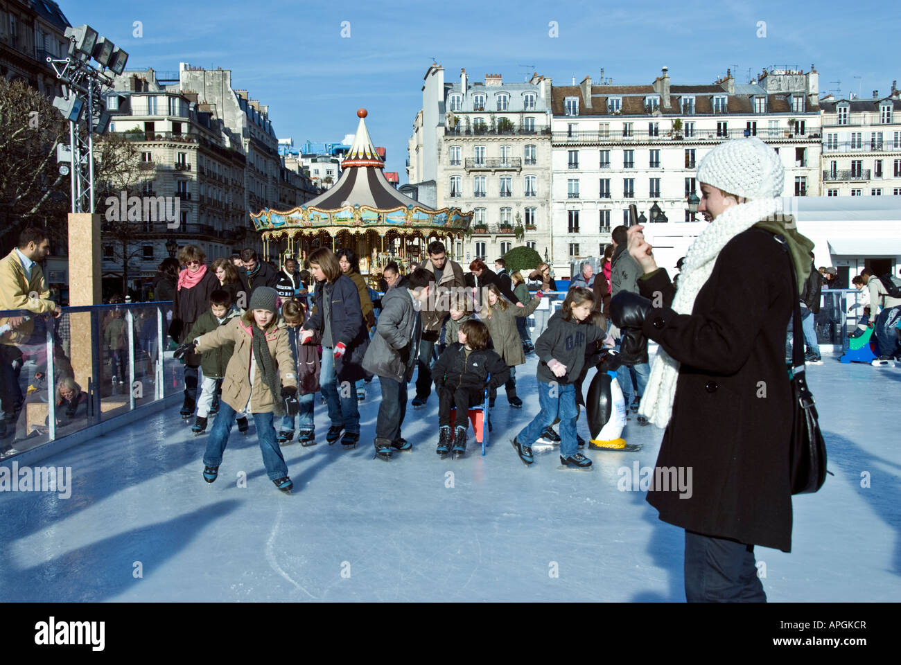 Paris France, Large Crowd People, Families Public Ice Skating on Street Skating Ring winter scenes, family sports Stock Photo