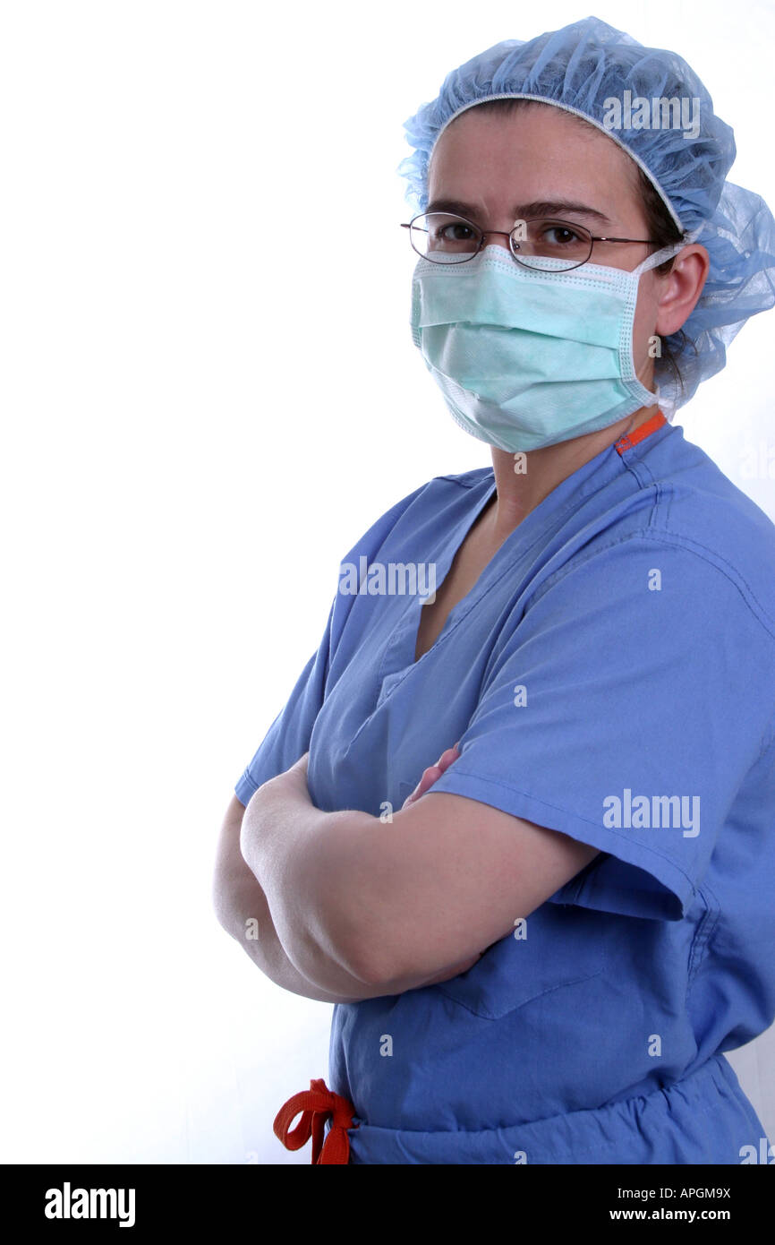 A nurse or surgeon wearing scrubs and surgical mask Stock Photo