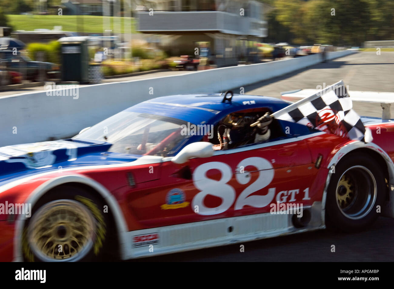 Paul Newman winning racecar driver waves checkered flag at Lime Rock