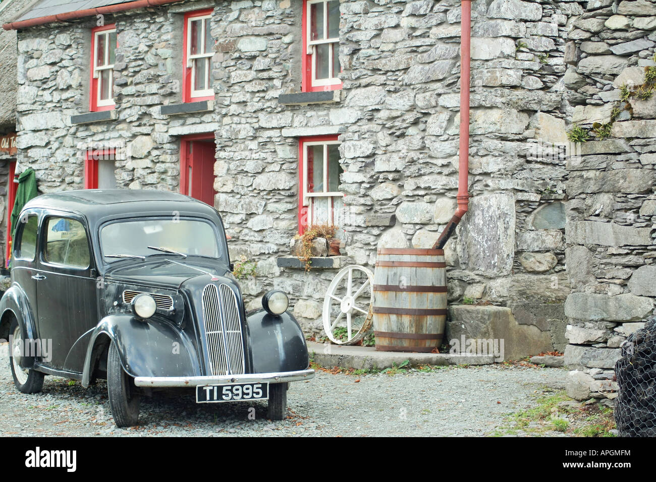 Antique car parked in front of old stone house Stock Photo - Alamy