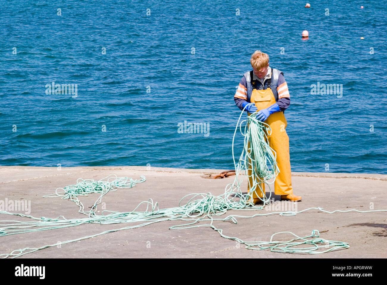 Fisherman with tangled rope at Fionport Isle of Mull Scotland May 2007 Stock Photo