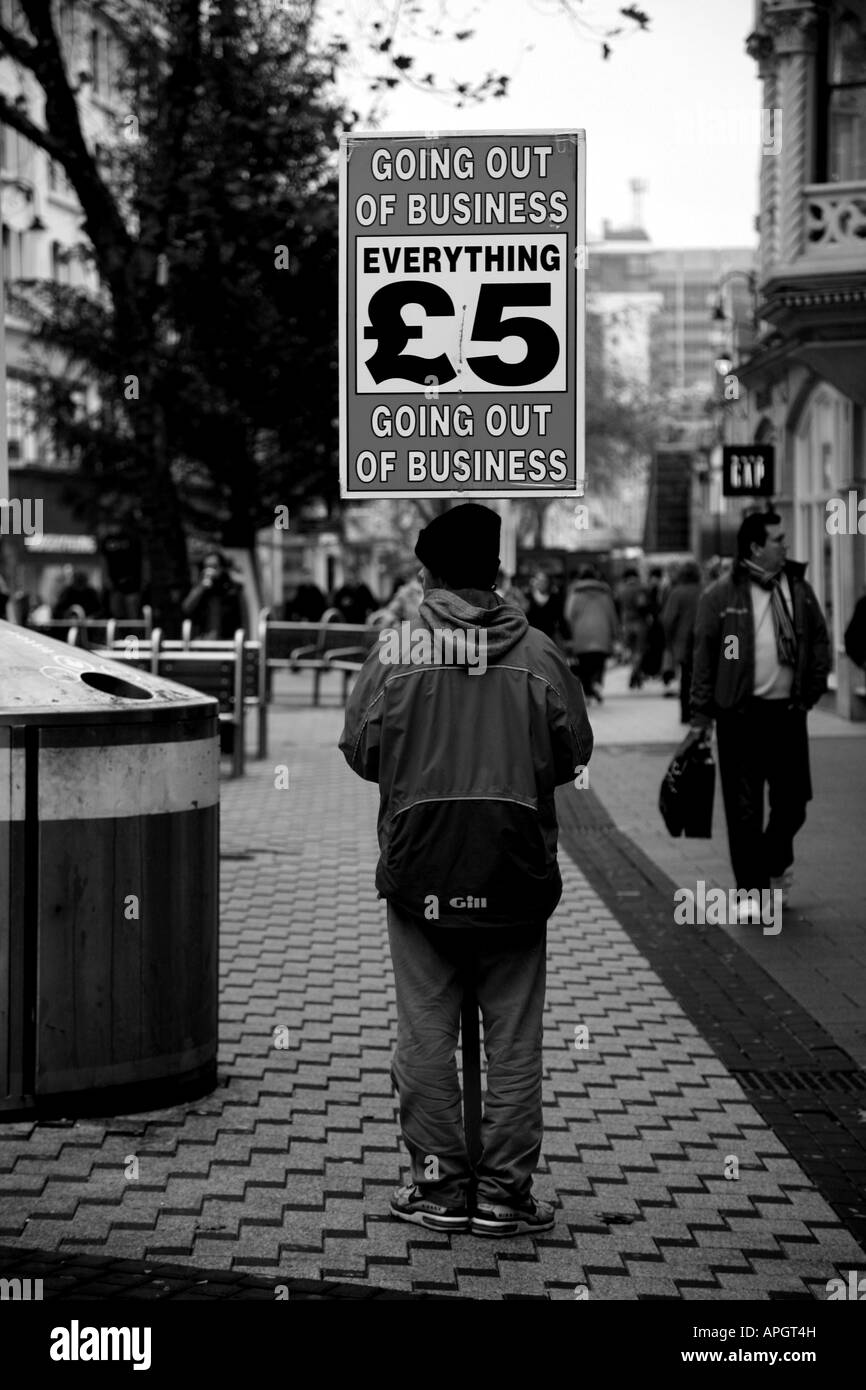 'Going out of business', man with placard, Queens Street, Cardiff, Wales, UK Stock Photo