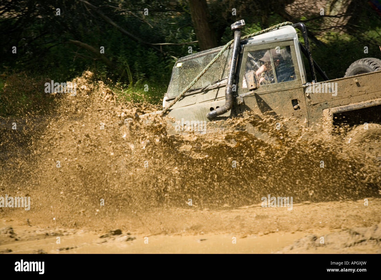 Landrover Lightweight going through deep mud Stock Photo