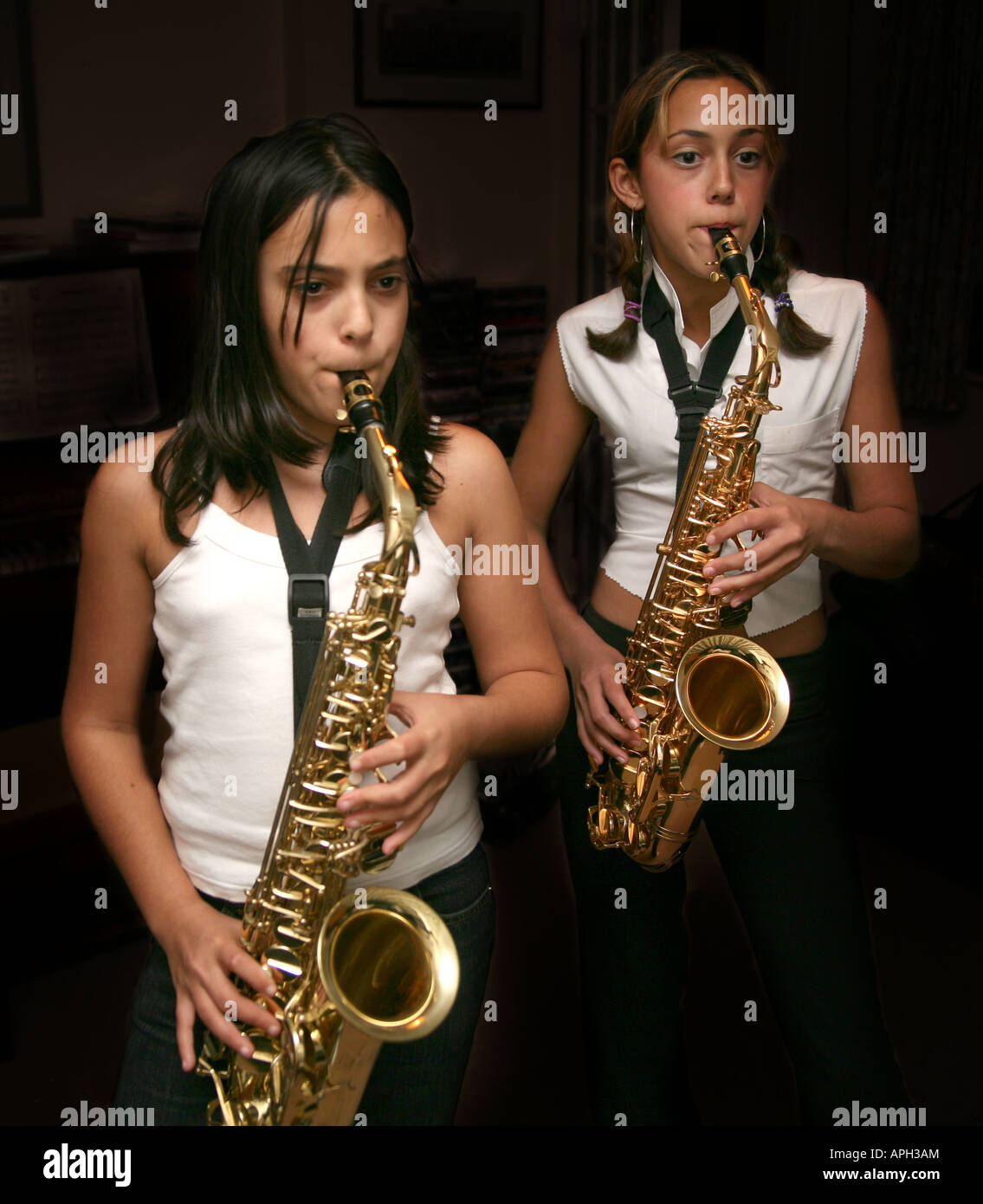Two girls playing saxophones Stock Photo