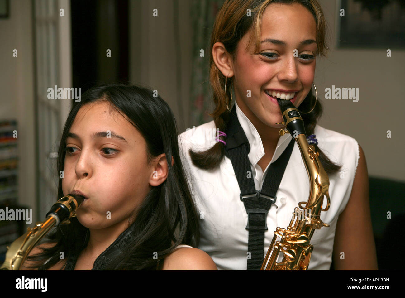 Two sisters playing saxophones Stock Photo