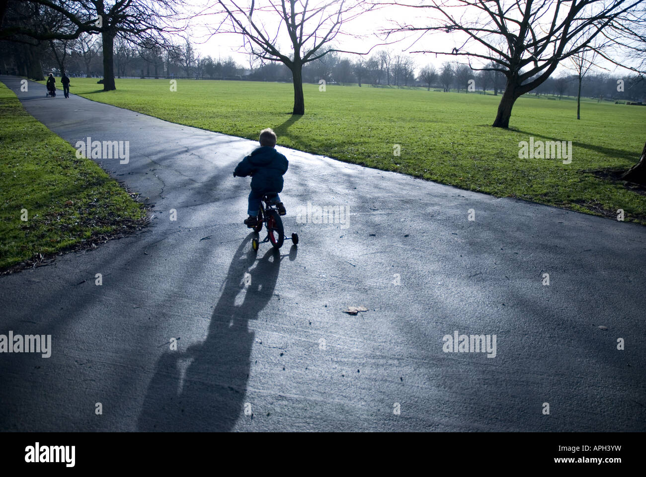 Kid on bicycle with stabilisers Stock Photo