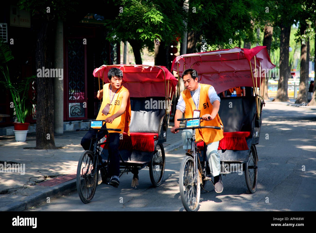 Two tricycle taxi drivers near Qianhai Lake Stock Photo - Alamy