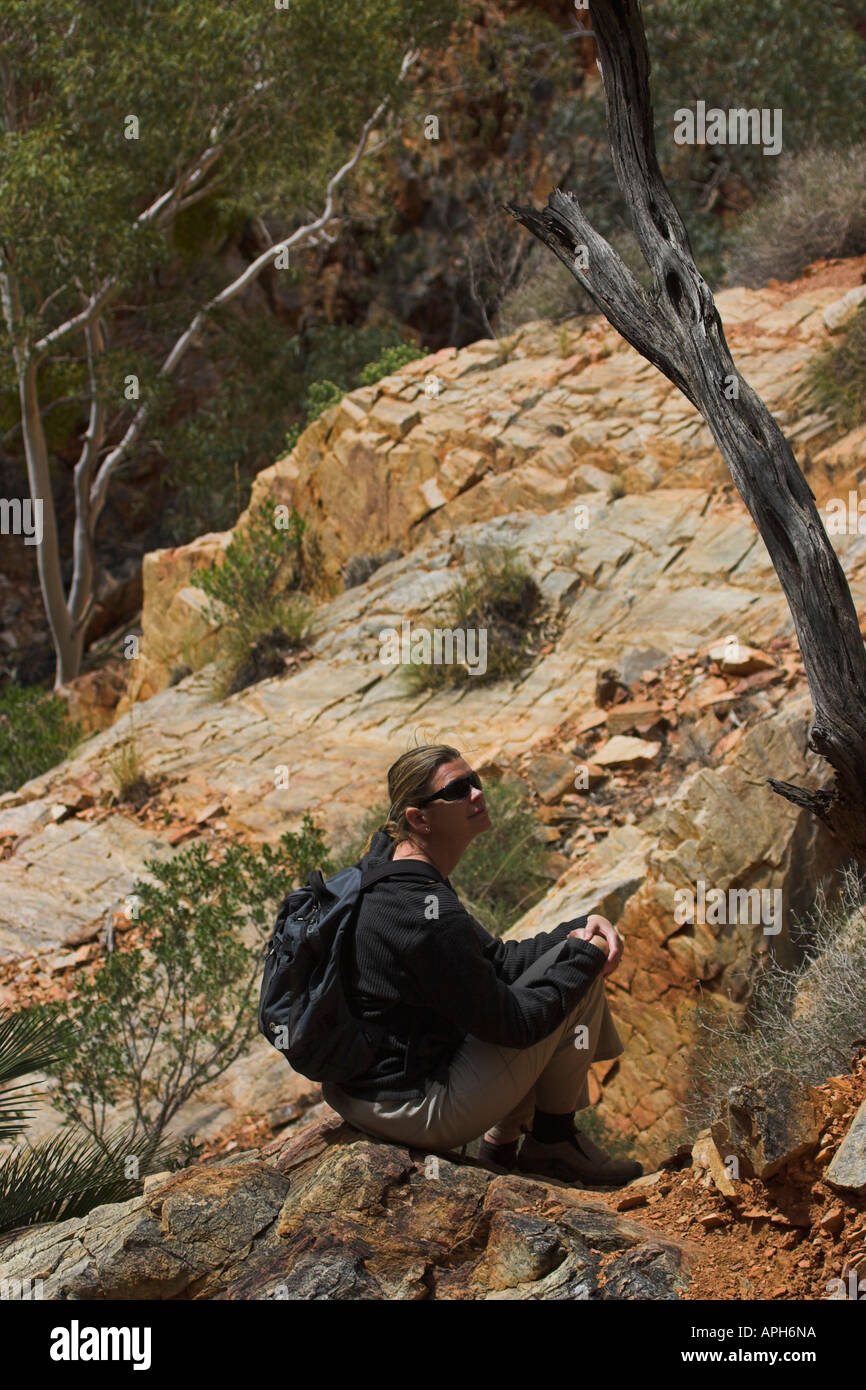 Resting hiker in the west macdonnell ranges in Australia Stock Photo