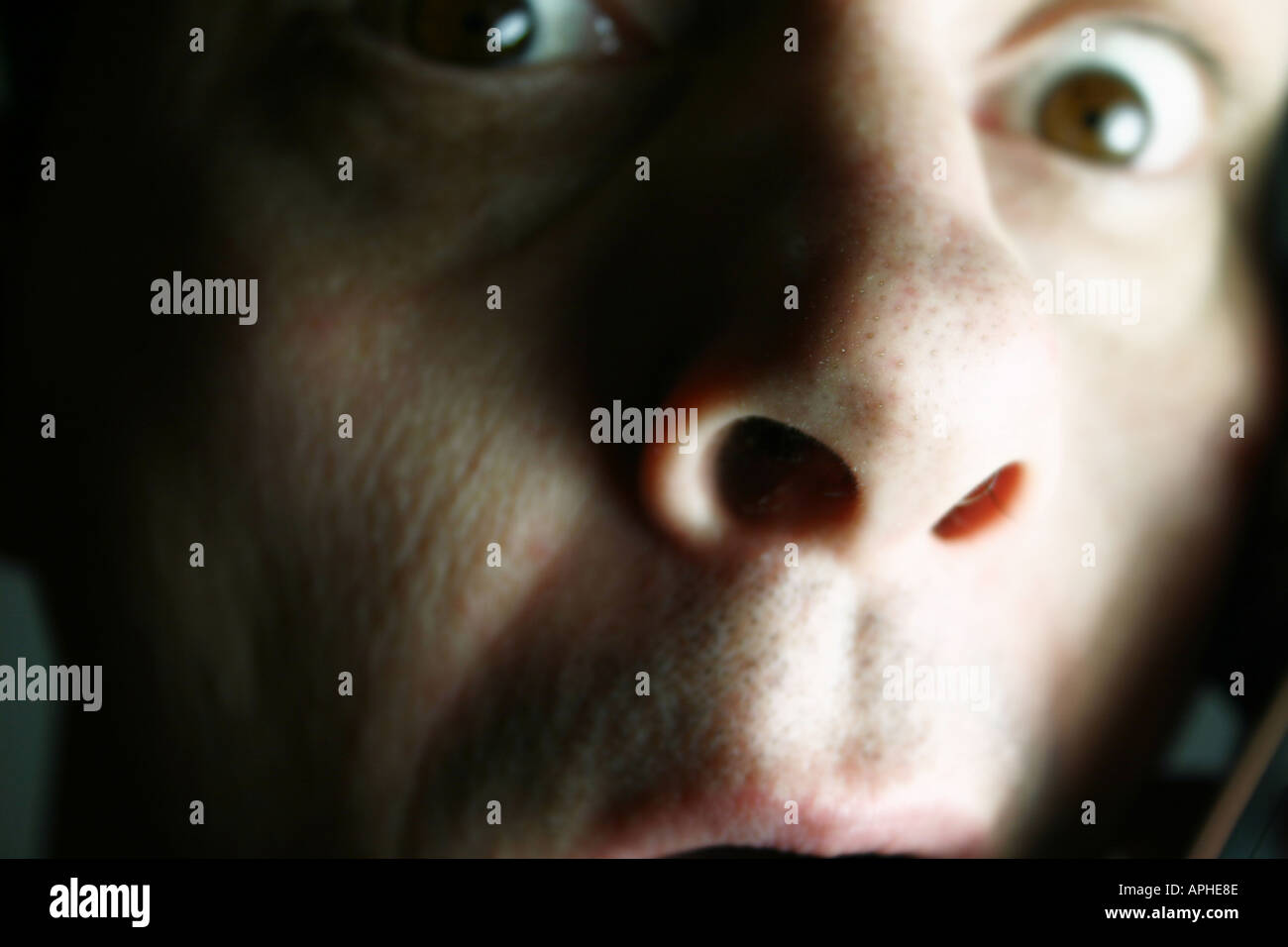 Close up of shocked male face eyes wide open Stock Photo