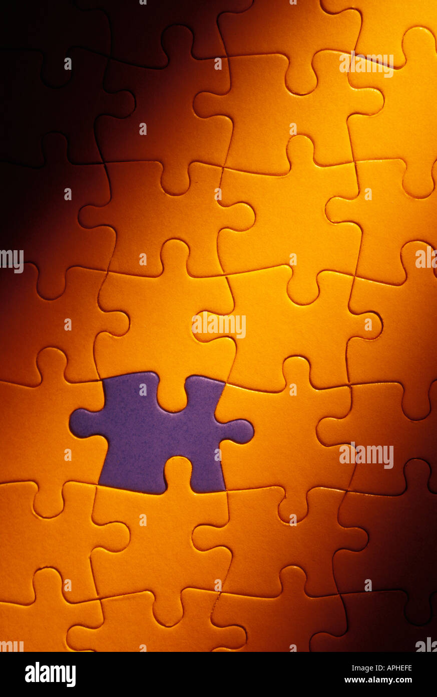 Blue puzzle piece fitted in in yellow puzzle Stock Photo