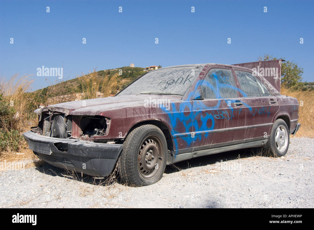 Abandoned Mercedes Benz 190E, left at the road, greece 2006. Stock Photo