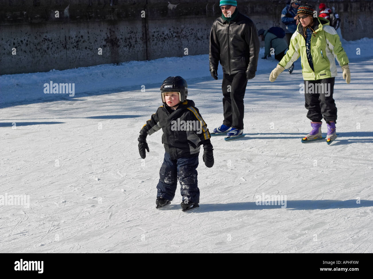 Little boy in protective gear ice skating Stock Photo Alamy