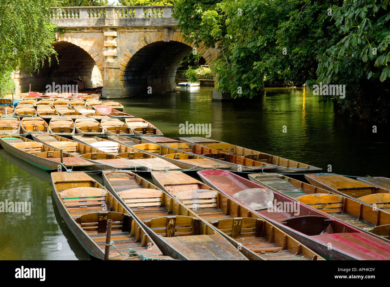 Rows of punts moored beneath Magdalen Bridge, Oxford Stock Photo