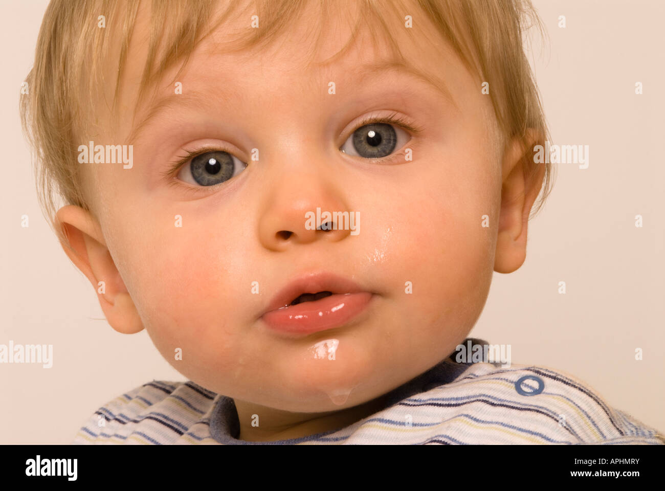 Baby boy eleven months old dribbling due to teething, wet chin Stock