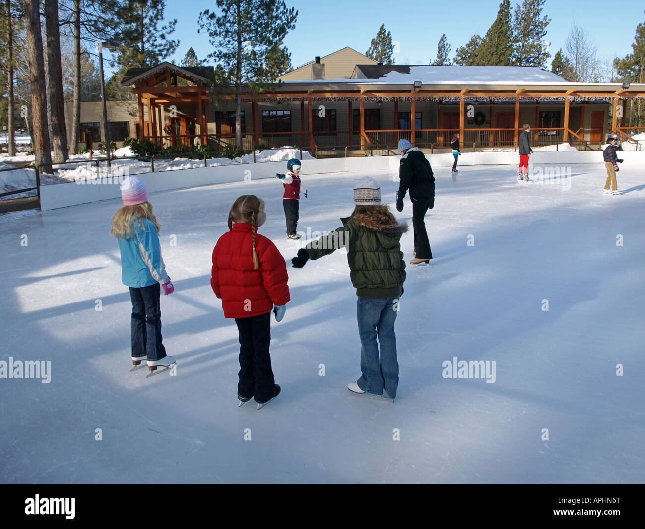Young ice skaters take an ice skating lesson at an ice rink in Bend in