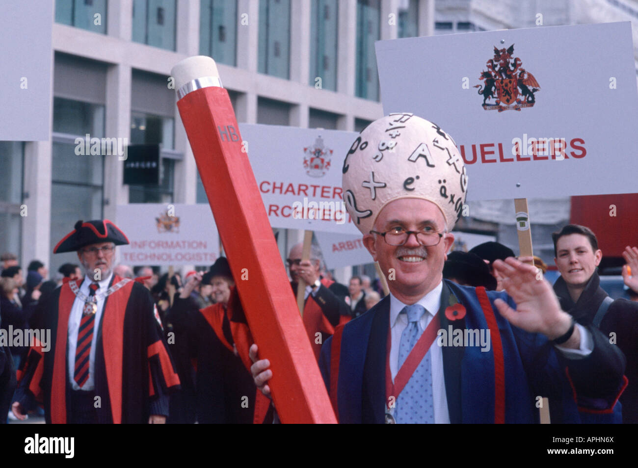 Egghead with large head covered in symbols and a giant pencil, Lord Mayors Show, Cheapside, City of London, England Stock Photo