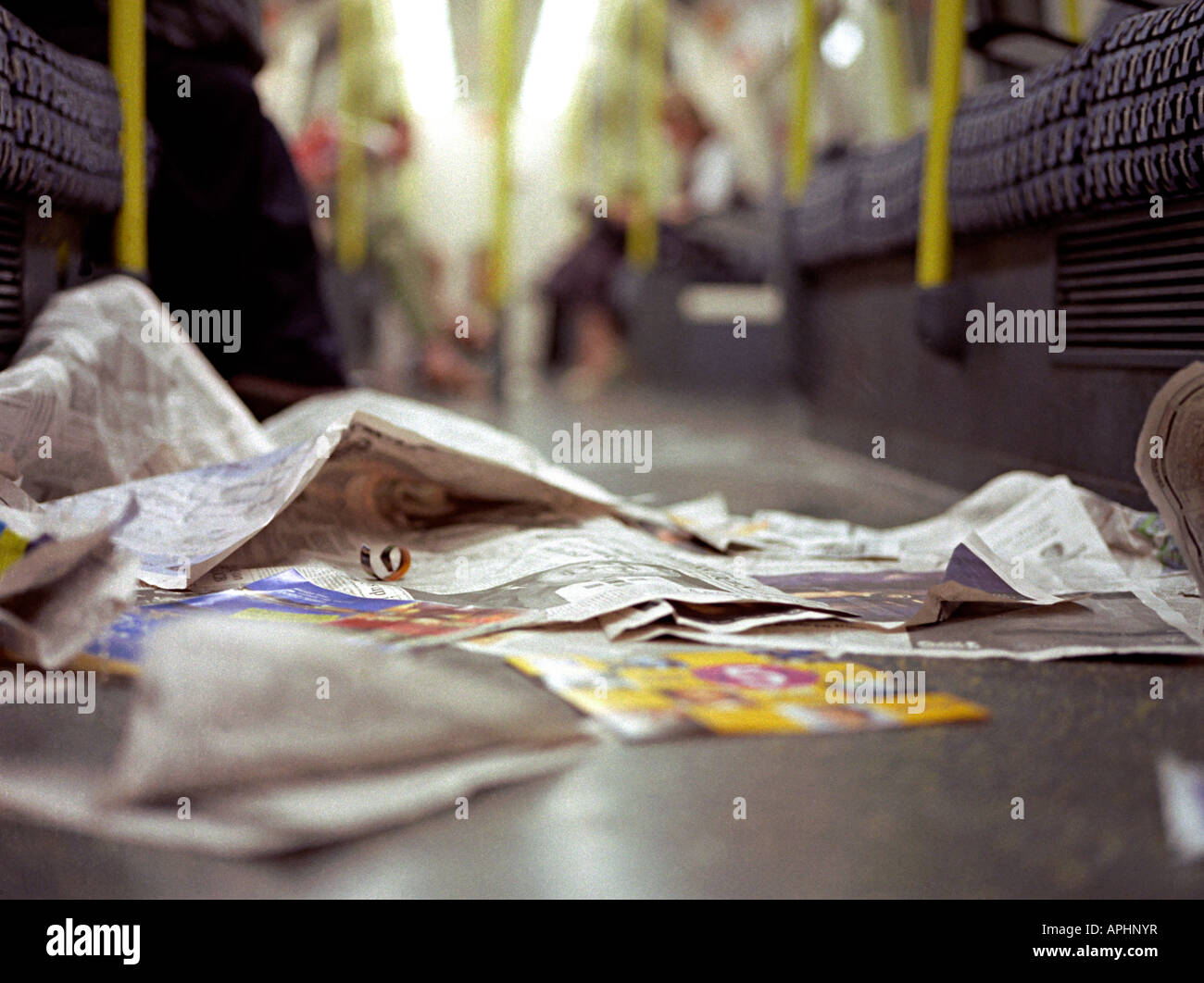 rubbish on the floor of the tube underground in london from free newspapers Stock Photo