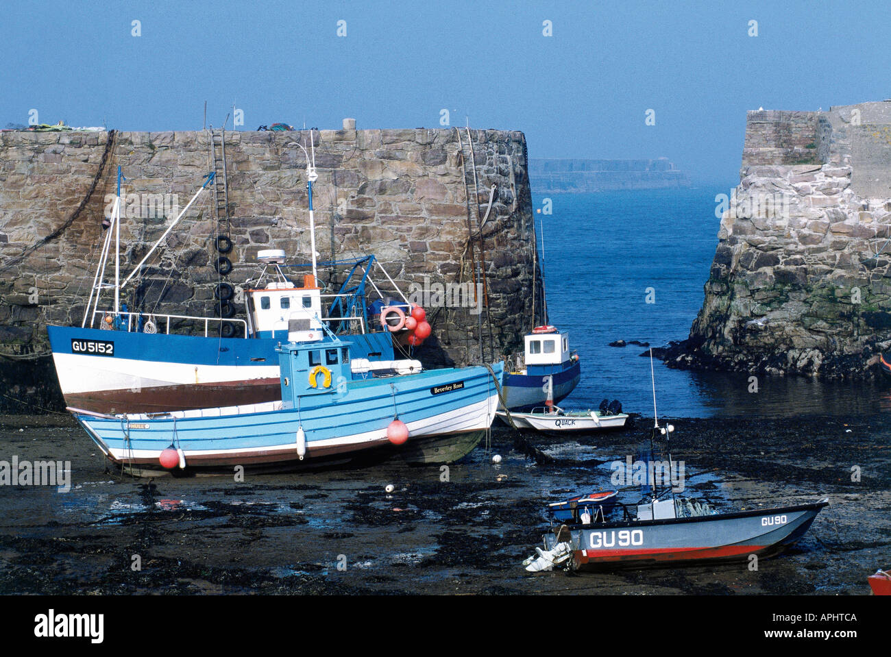 Fishing boats resting on a harbour bed in Braye Alderney Channel Islands Stock Photo