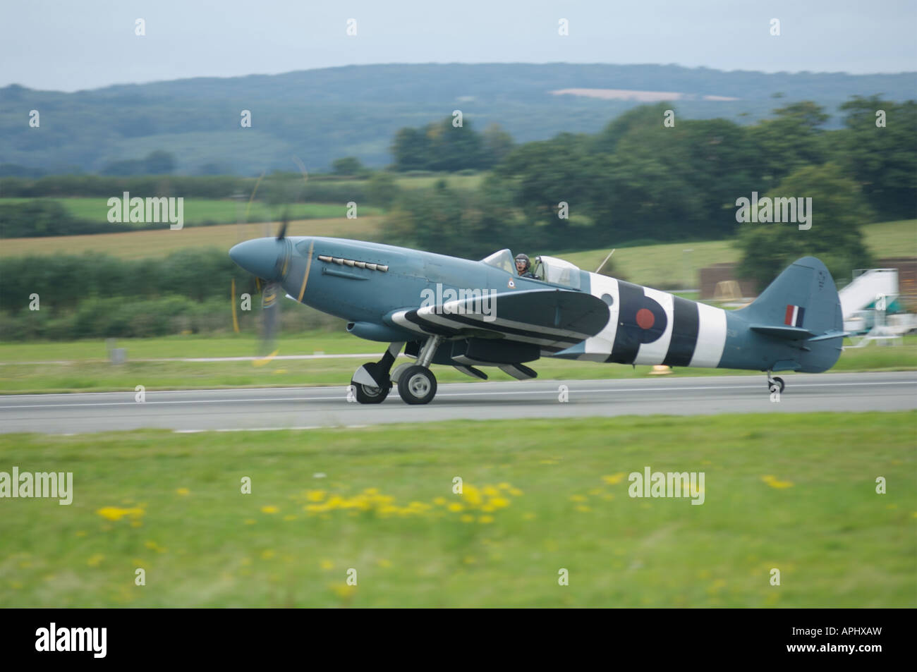 spitfire landing at Exeter Airport Uk England Stock Photo