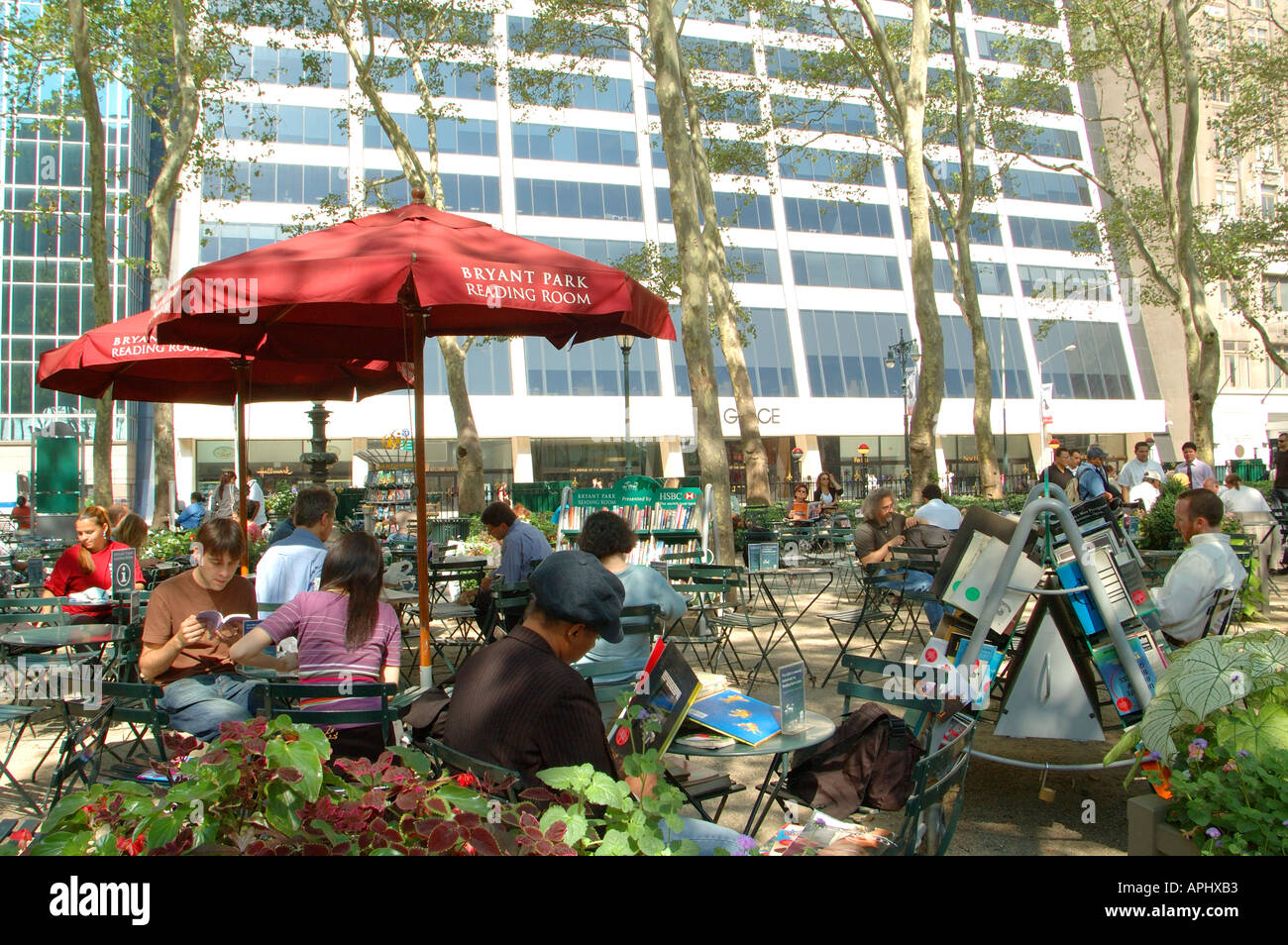 People relaxing in Bryant Park reading room, New York, NYC Stock Photo