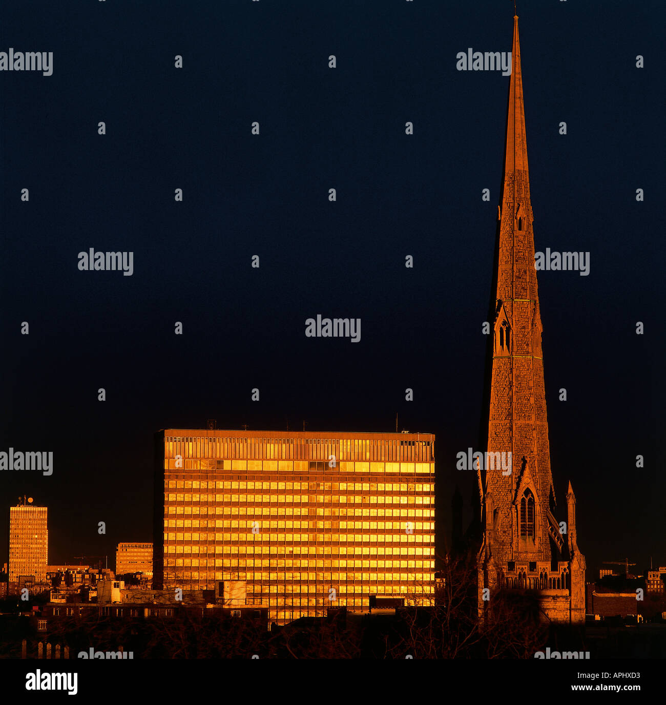 This shot over London compares and contrasts 19th and 20th century architecture cast in a golden glow as the sun sets England Stock Photo