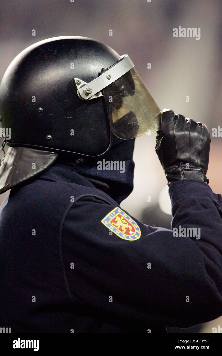 Spectators Riots Riot policeman watching the spectators Stock Photo - Alamy