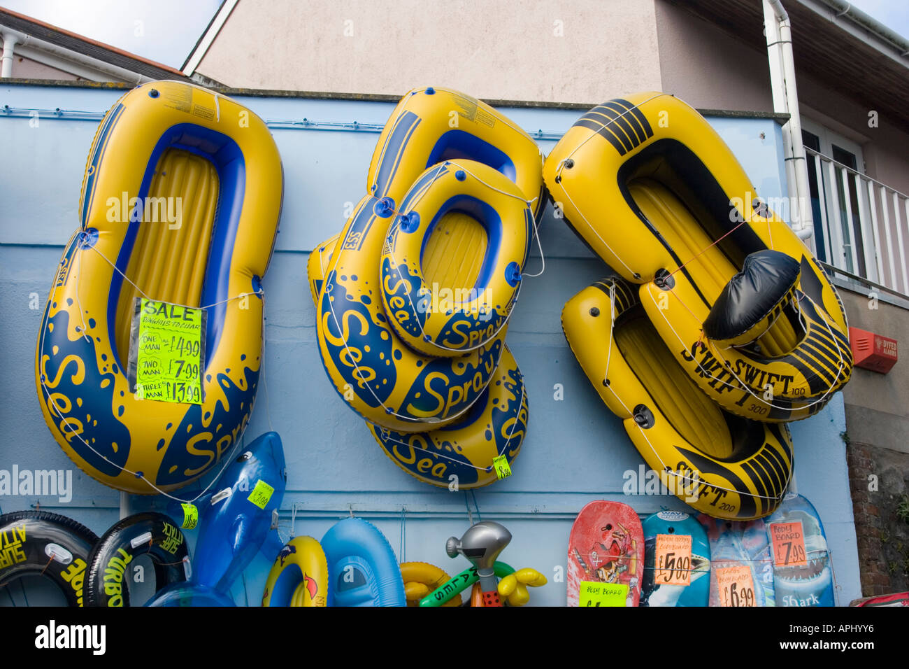 Inflatable dinghies on display outside a shop in Pembrokeshire Stock