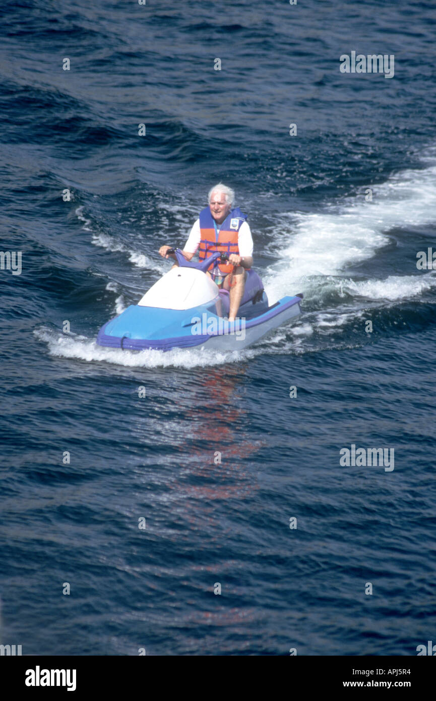 Never too old!Watersports are not only for the young! Older man enjoying the sport on a Jetski Stock Photo